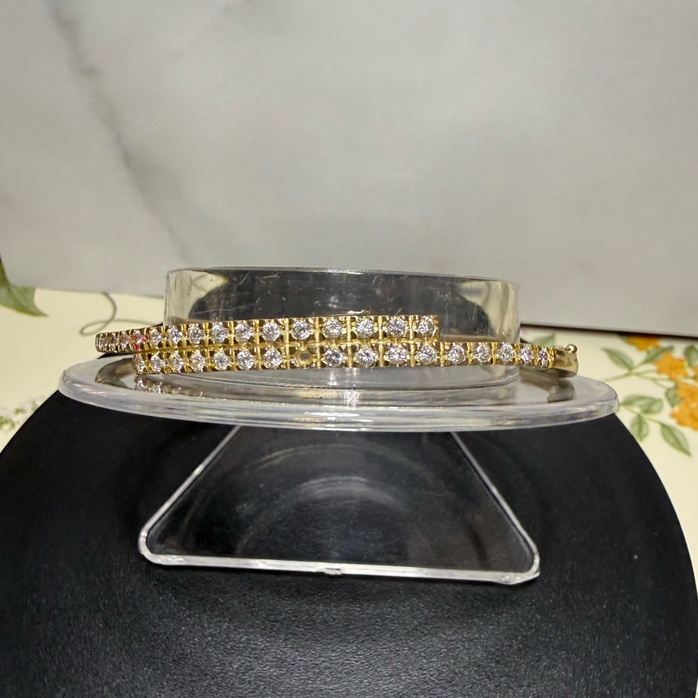 Gold tone and zircon studded bangle bracelet